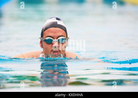Young man swim in pool. face of strong man swimming Stock Photo
