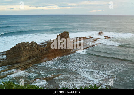 Magnific big rock in ocean on sunset light time Stock Photo
