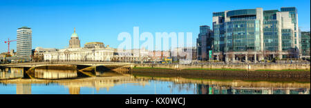 DUBLIN, IRELAND - 4 FEBRUARY 2017: Panoramic image of river Liffey waterfront in Dublun, on the right is IFSC Custom House Quays, on the right histori Stock Photo