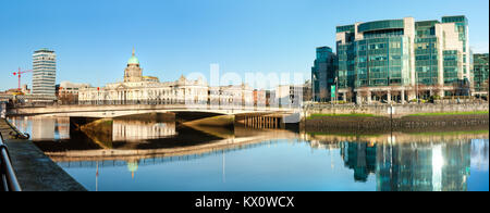 DUBLIN, IRELAND - 4 FEBRUARY 2017: Panoramic image of river Liffey in Dublun, on the right is IFSC Custom House Quays, on the right historic Customs h Stock Photo