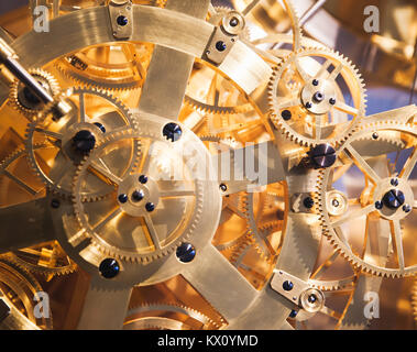 Vintage clock mechanism, fragment with many shiny gears Stock Photo