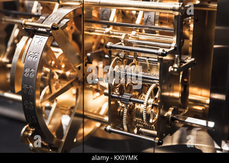 Mechanism of old clock, fragment with shiny gears and calendar days counter Stock Photo