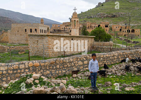 View over the abandoned village of Killit, near the town of Savur in Mardin with a local boy. The village was inhabited by Syrian Orthodox Christians. Stock Photo