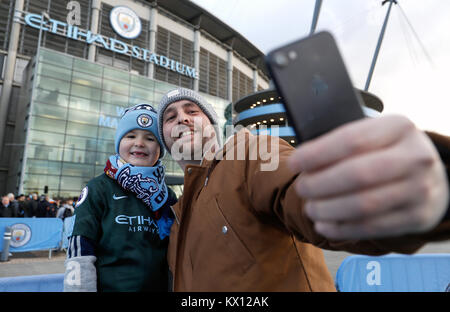 Manchester City fans take a selfie outside the stadium during the FA Cup, third round match at the Etihad Stadium, Manchester. Stock Photo
