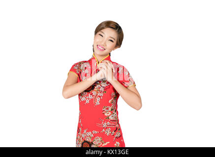 Asian woman in Chinese dress traditional cheongsam with gesture of congratulation in Chinese new year isolated on white background with clipping path. Stock Photo