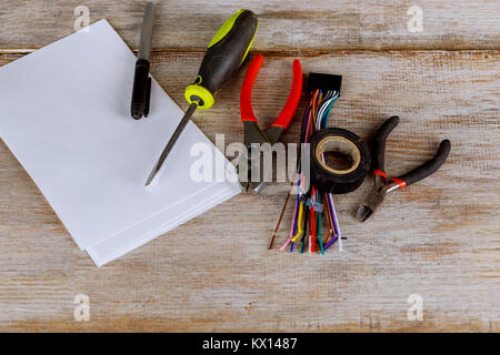Tools for electrical installation isolated on metal surface Insulation strippers electric wire cutter pliers Stock Photo