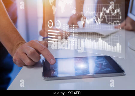Team of business people analyzing marketing, sales, operations, financial, or trading metrics on digital analytics report dashboard with key performan Stock Photo