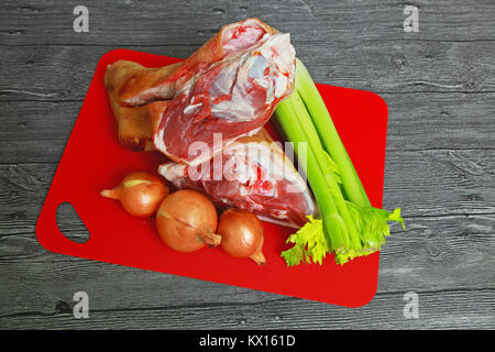 Fresh pork leg with onion and celery Stock Photo