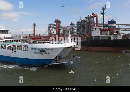 Kosa Chushka, Temryuk district, Krasnodar region, Russia - July 18, 2017: Ferry 'Protoporos 4' with the lowered gangway approaches the pier in the por Stock Photo