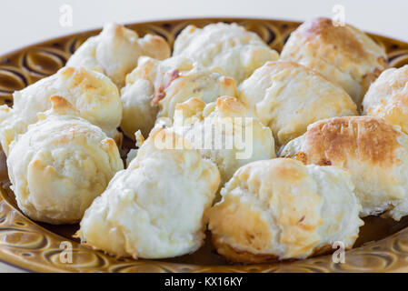 Puff pastry wrapped around a sausage (wurstel) and baked in the oven. Crispy homemade stuffed panzerotti with wurstel and cheese Stock Photo