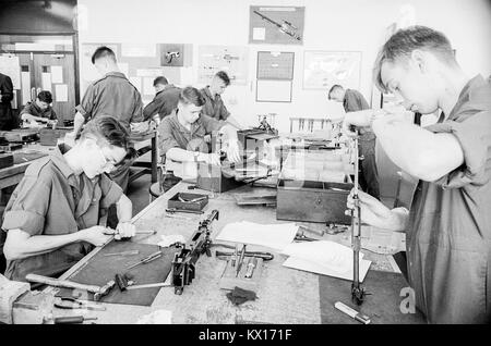 British army squaddies undergoing basic training in a workshop armoury for weapons maintainance training, England, 15th June 1993 Stock Photo