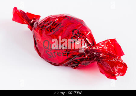 Quality Street chocolate by Nestle – strawberry delight chocolate, red Quality Street, isolated on white background Stock Photo