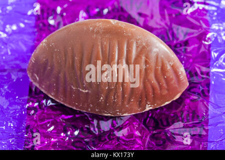 Quality Street chocolate by Nestle - the purple one, hazelnut and caramel in milk chocolate with chocolate removed from wrapper Stock Photo