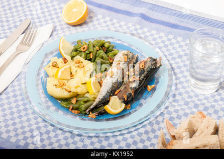 Homemade portuguese mackerel fish meal with potatoes and veggies. Stock Photo