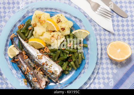 Homemade portuguese mackerel fish meal with potatoes and veggies. Stock Photo