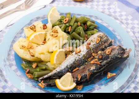 Homemade portuguese mackerel fish meal with potatoes and veggies. Stock Photo