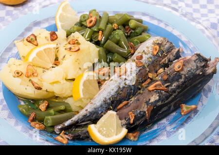 Homemade portuguese mackerel fish meal with potatoes and veggies. Stock Photo