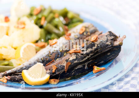 Homemade portuguese mackerel fish meal with potatoes and veggies. Stock Photo