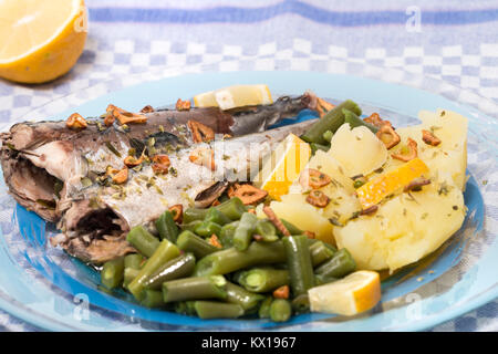 Homemade portuguese mackerel fish meal with potatoes and veggies. Stock Photo