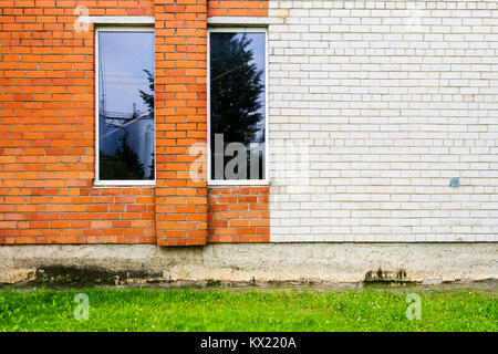 Red and white brick wall with some windows Stock Photo