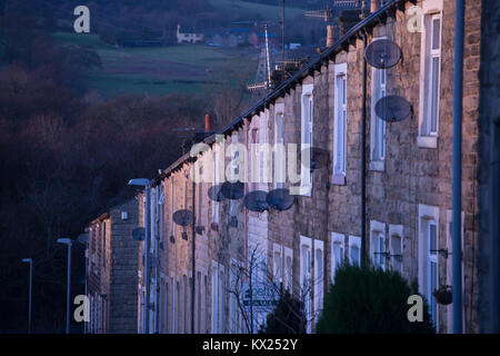 A row of terraced houses with satellite dishes in Nelson, Lancashire Stock Photo