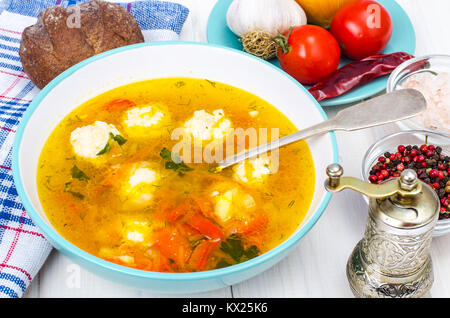 Plate of soup with meatballs on white wooden table Stock Photo