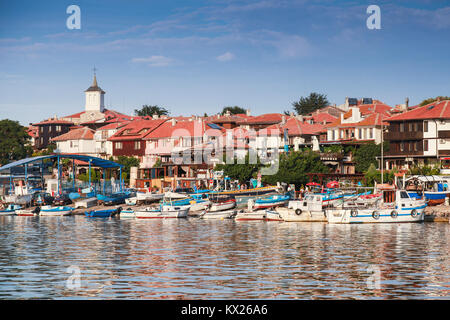 Nesebar, Bulgaria - July 20, 2014: Coastal skyline of old port of Nesebar. Ordinary people walk on street Stock Photo