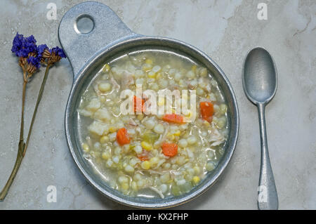 Chicken Corn soup with rivels in metal soup bowl.  It is an Amish classic soup recipe. Stock Photo
