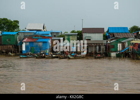 A small shanty town, squatter settlement of poor houses of wood and corrugated metal sheets, shanties shacks next to Mekong River, Phnom Penh Cambodia Stock Photo
