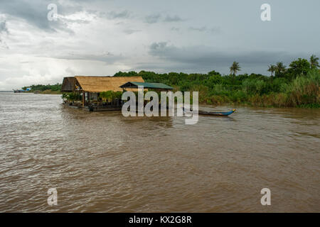 A small hut and corrugated metal shelter used as a high end accommodation hotel floating on the Mekong River, Phnom Penh, Cambodia, South East Asia Stock Photo