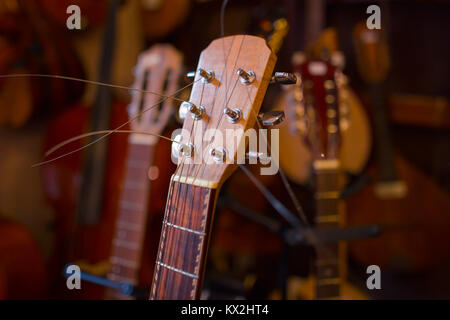 guitar neck detail in the music instrument shop with blurred background Stock Photo