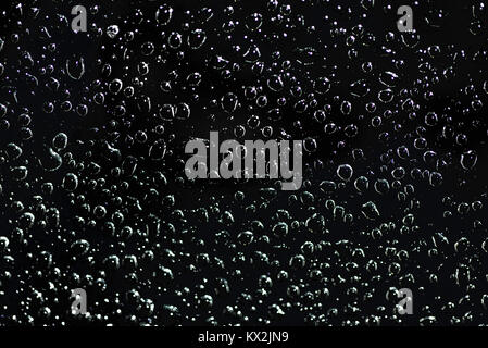 round water drops on clear glass night Stock Photo