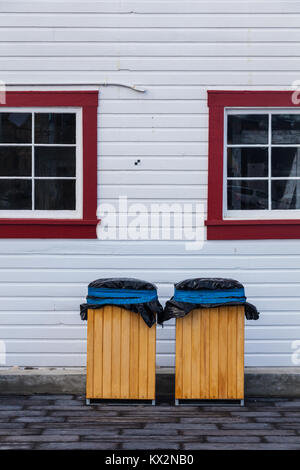 Abstract image of two wooden garbage cans against a white wall Stock Photo