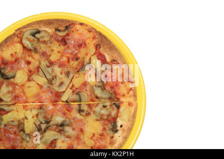 Top view of veggie pizza on a yellow plate isolated on white background Stock Photo
