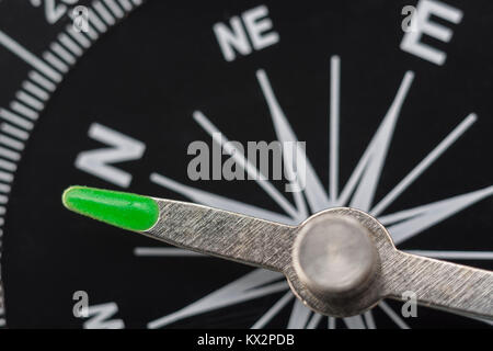 Macro-photo of compass rose face with needle. Concept navigation, bearing, direction, compass north. Stock Photo