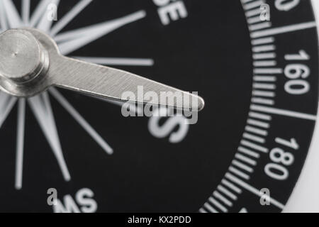Macro-photo of compass rose face with needle. Concept navigation, bearing, direction, compass south. Stock Photo