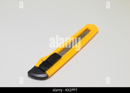 Yellow and black boxcutter tool icon. Household box cutter instrument for general or utility purposes. Snap-off blade stationery knife Stock Photo