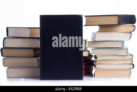 several piles of old books on white background Stock Photo