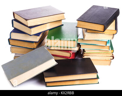 several piles of old books on white background Stock Photo