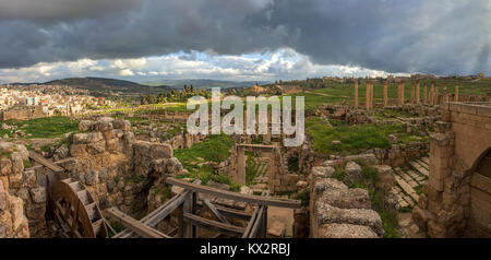 A water powered saw mill to cut stones in the ancient city of Gerasa after a storm with dark grey clouds Stock Photo