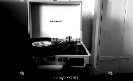 Crosley retro style portable record player with vinyl album Stock Photo