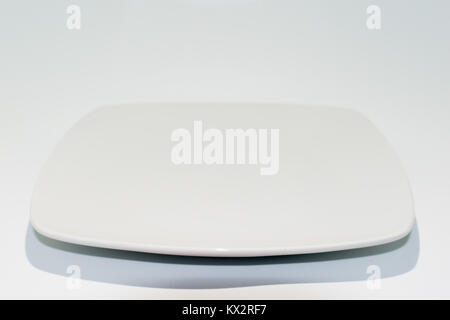 Empty ceramic plate isolated on white background. Square dish Stock Photo