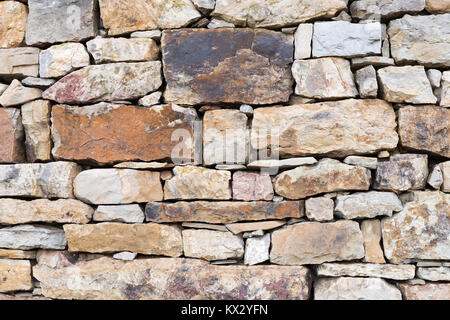 Section of dry stone wall made of various sized stones Stock Photo