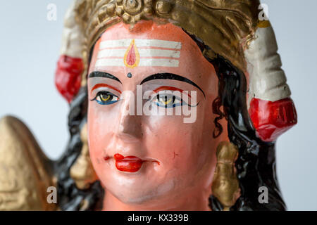 Brightly coloured hand painted face of a Hindu deity statue Stock Photo