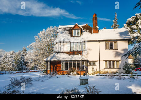 Prime residential property: Large detached Tarrant house and garden, Surrey, SE England, with a thick covering of snow after heavy snowfall in winter Stock Photo