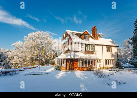 Prime residential property: Large detached Tarrant house and garden, Surrey, SE England, with a thick covering of snow after heavy snowfall in winter Stock Photo