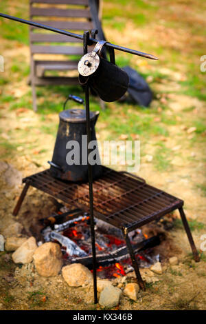 Ancient tea kettle on campfire. Stock Photo