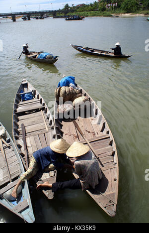 Boats and women on the river in Hoi An, central Vietnam Stock Photo