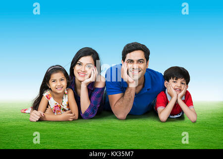 Happy Family Parents And Children Lying Grass Together In Park Stock Photo