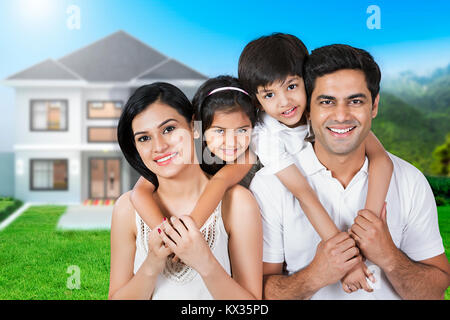 Happy Family Parents Giving Children Piggyback Ride Outside At Home Stock Photo